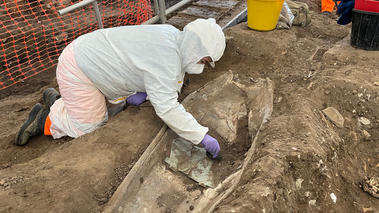 Archaeologist Amber Furmage excavates the lead coffin recently found at Leicester Cathedral. Image: ULAS