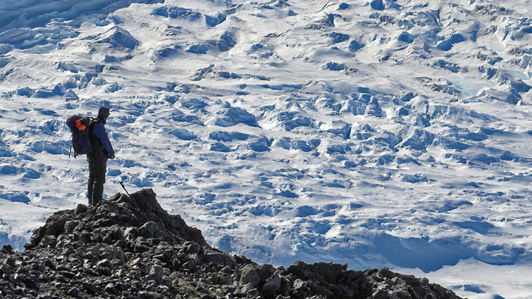Professor John Smellie standing on the caldera rim of Mt Sidley, in Marie Byrd Land (West Antarctica), Antarctica's highest volcano, in 1989.