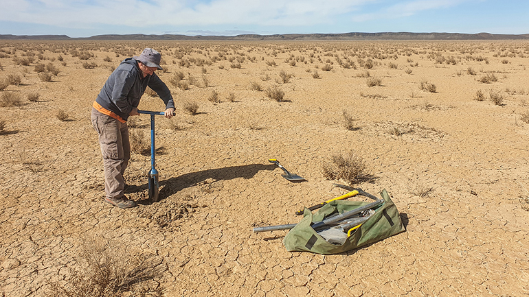 Andrew Carr collecting sediment samples dating to the Last Glacial Maximum from the dry lakebed at Swartkolkvloer. Image credit: Brian Chase.