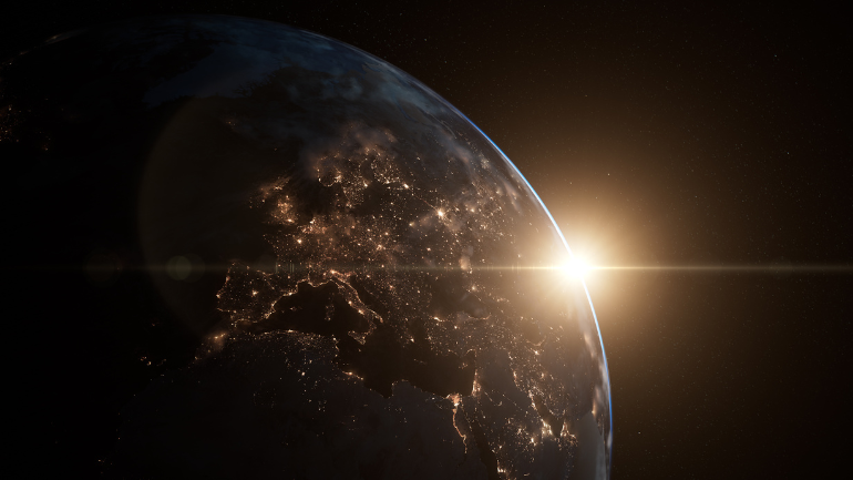 image of the earth from space, in darkness, with city lights on display