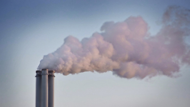 A chimney stack with smoke.