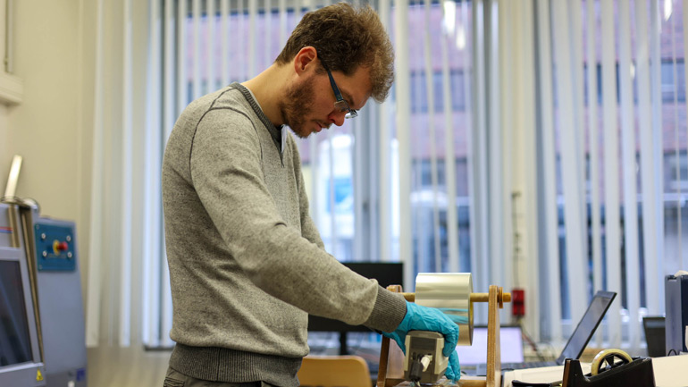 Tim van Peer (University of Leicester) determining the core’s colours. Credit: parker@ECORD_IODP