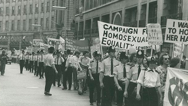 Marchers, banners and police at Gay Pride march in London