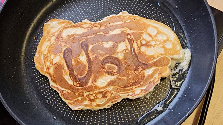 A pancake with 'UoL' written on.