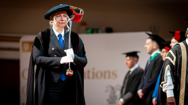 Sonata Gudaitiene on stage carrying the mace