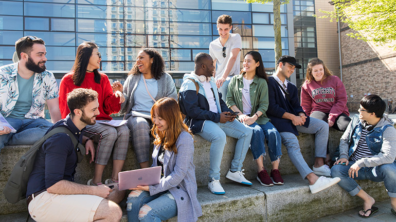 A group of students relaxing outside the David Wilson Library.