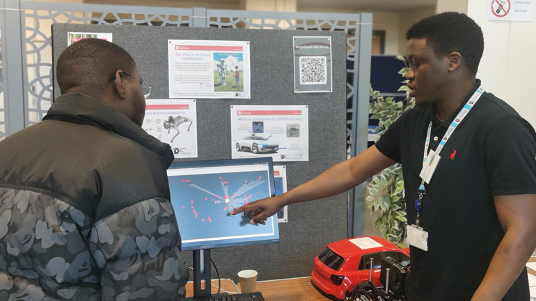 The DriverLeics team demonstrating their work to visitors.