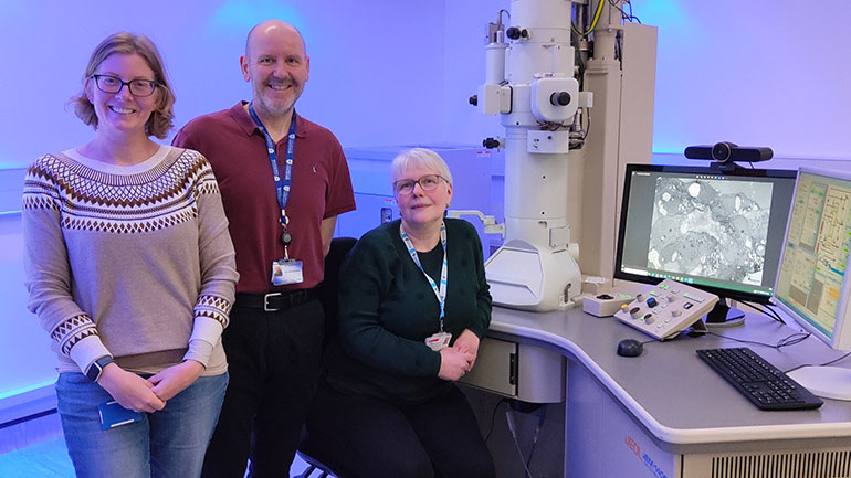 Transmission Electron Microscope (TEM) Unit Manager, Natalie Allcock, Dr Rob Hirst, and Anna Straatman-Iwanowska (seated) at the TEM in  the University of Leicester’s Hodgkin Building.