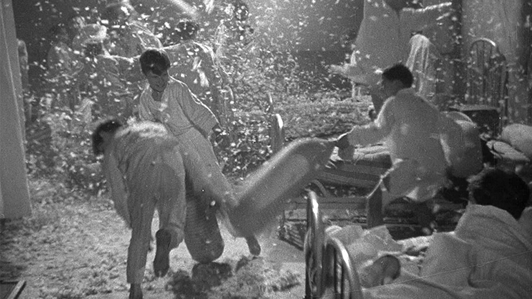 Still from Jean Vigo's Zéro de conduite (1933). Black and white image of boys having a pillow fight.