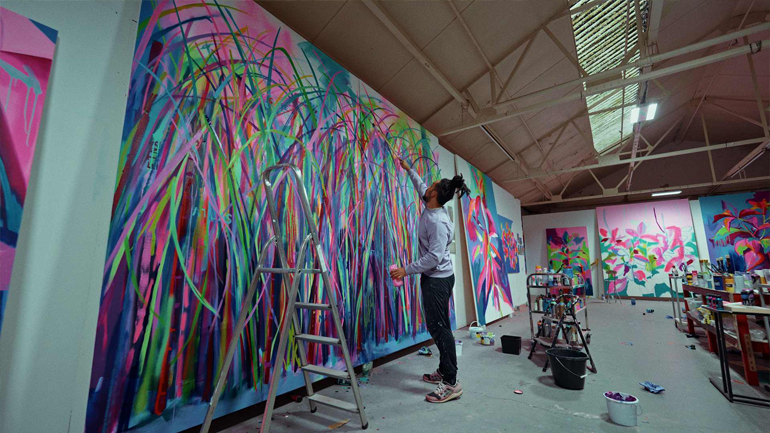 Tim Fowler working on a large painting in his studio. Credit: Nik Trzcinowicz