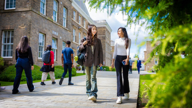 students walking past university buildings