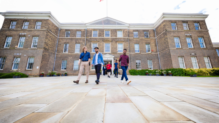 university buildings with some students walking past
