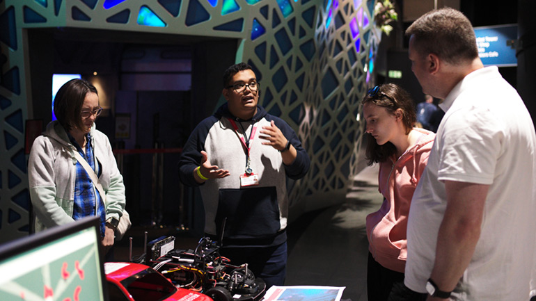 Visitors learn about the work of the DriverLeics team at the UK in Space Festival.