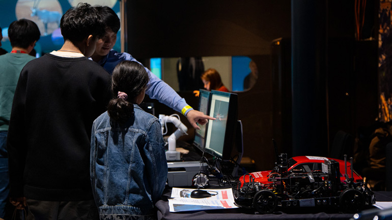 Visitors learn about the work of the DriverLeics team at the UK in Space Festival.
