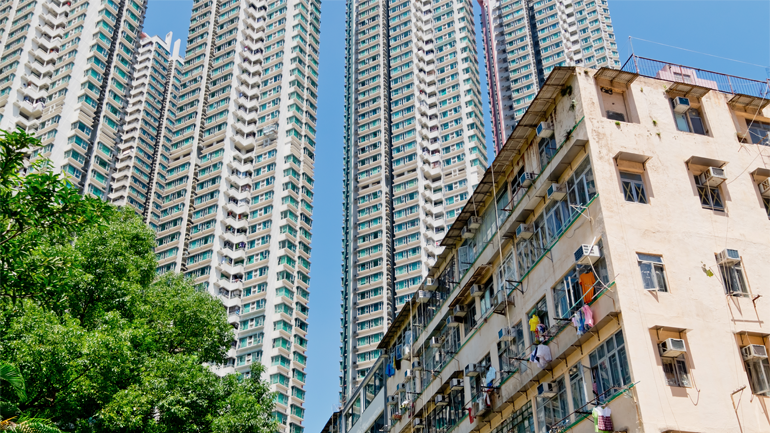High rise luxury apartments in the background with run down apartments in the foreground