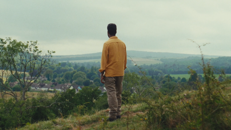 man looking over rural valley