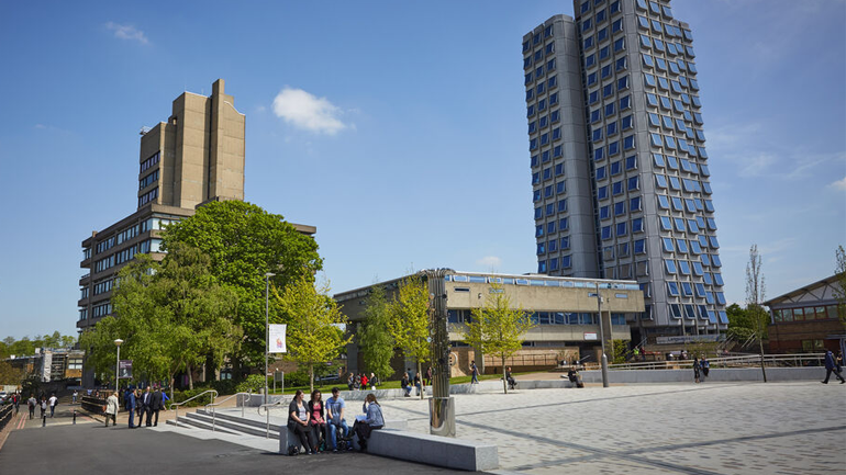 View of University of Leicester's campus showing Attenborough Tower on the right and Charles Wilson Building left. Centenary Square is in the foreground.