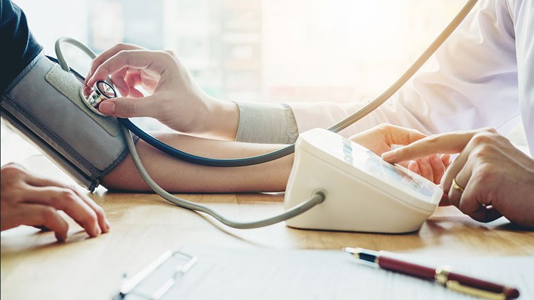 Patient blood pressure being taken by doctor