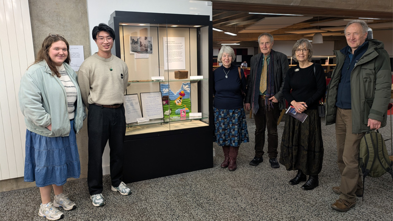 Students stand with the relatives of Harry Peach in David Wilson Library