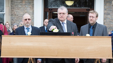 Leon Hunt, Dr Richard Buckley and Mathew Morris lay white roses on Richard III's coffin.