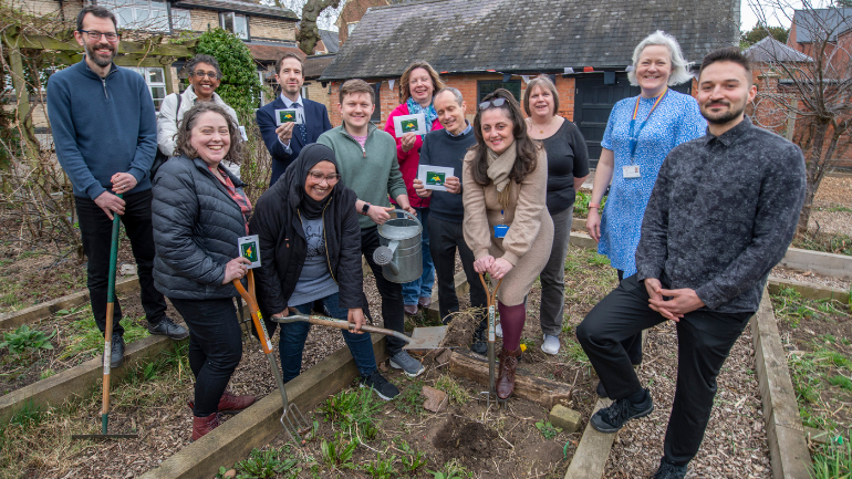 uni and council representatives planting seeds