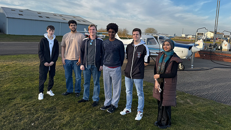 Students on the Aircraft Performance and Navigation module and the aircraft they conducted a flight test on.