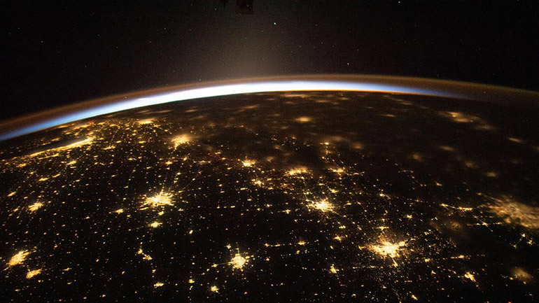 The sun's first rays begin illuminating Earth's atmosphere in this photograph from the International Space Station as it orbited 260 miles above the central United States. Credit: NASA