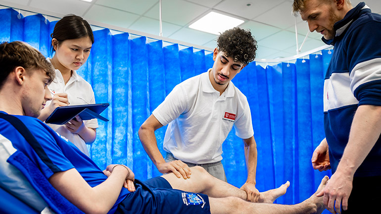Student physiotherapists at the University practicing their skills.