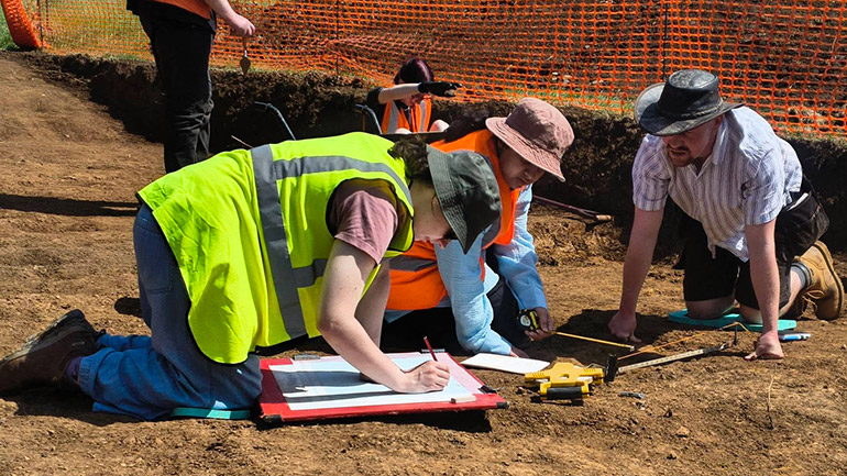 Students at work and recording medieval buildings at the Loddington field school.
