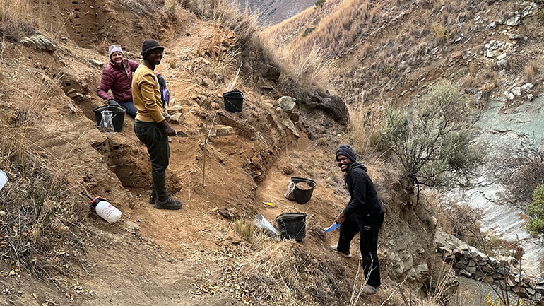 Sarah Theofanopoulos of California State University, Sacramento, local archaeologist Molopi Matela, and Lefa Leanya of Stellenbosch University, South Africa excavate the Likonong Rock Shelter in the mountains of Lesotho. Credit: Kyra Pazan, California State University, Stanislaus