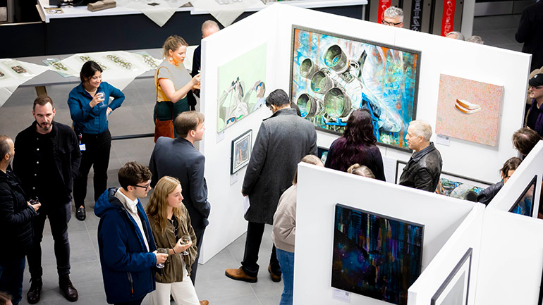 Visitors attend an art exhibition at Space Park Leicester.