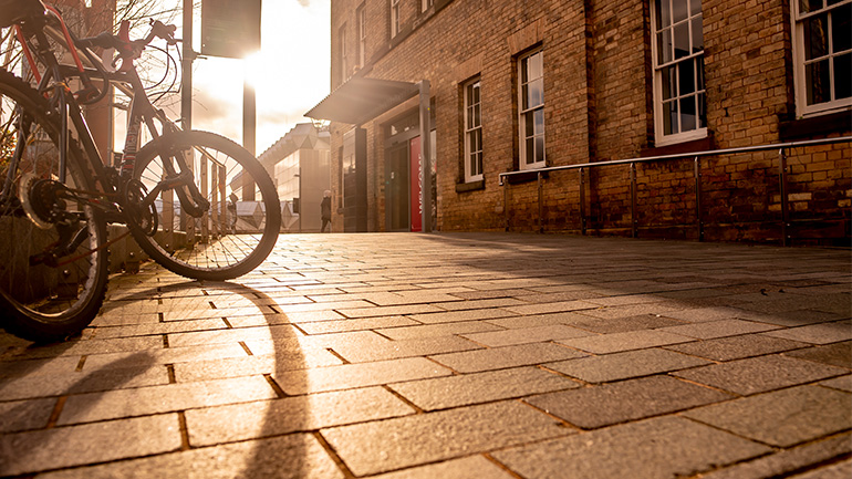 University of Leicester Law School building exterior with bicycles parked outside