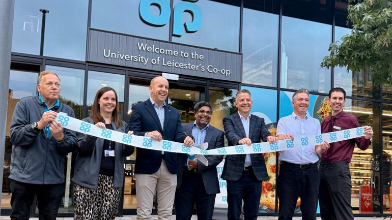 People taking part in a ribbon-cutting ceremony outside the University of Leicester's Co-op store.