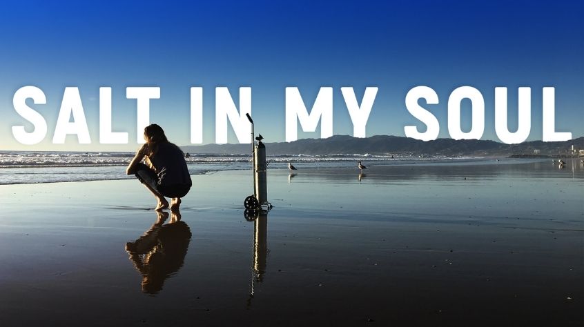 Mallory Smith on a beach with the words 'Salt in My Soul' superimposed into the background.