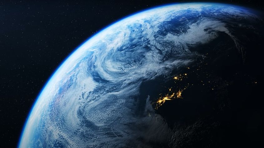 View of the Earth from space at night, with city lights.