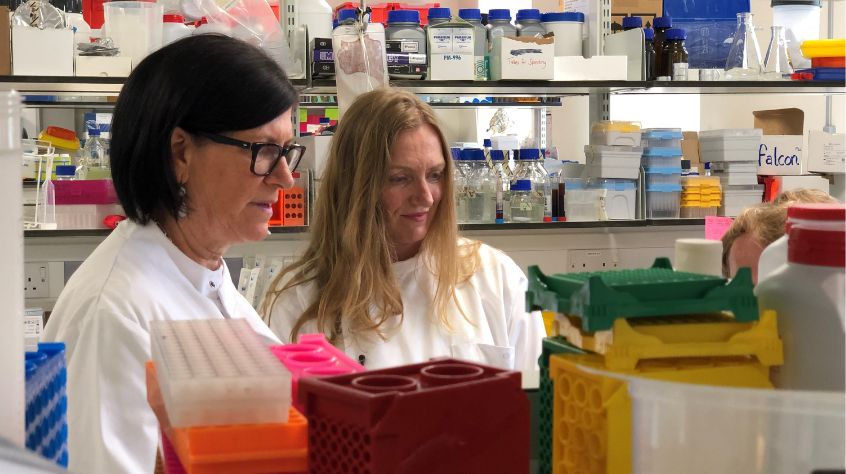 Diane Shader Smith and Professor Martha Clokie among microbiology lab equipment.