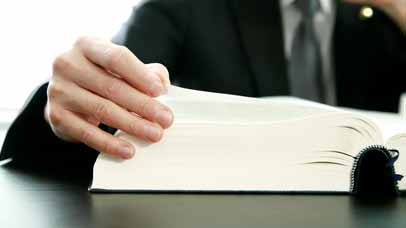 Person reading a  large book