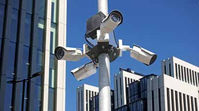 Security cameras in front of high-rise buildings