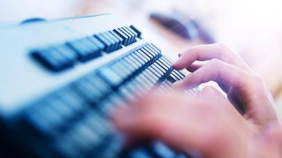 a person typing using a keyboard