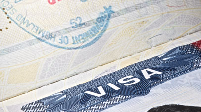 Close up of the word 'visa' in a passport.