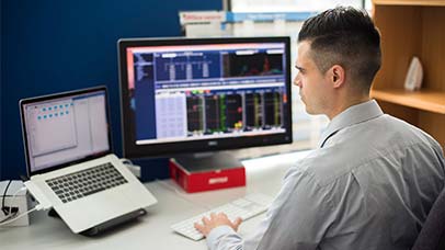 person using data on laptop and monitor screens
