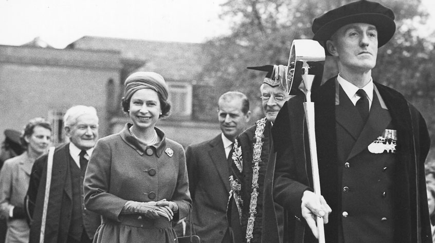 Her Majesty The Queen walking with senior academics
