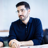 Man wearing glasses and a blue top