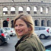 Headshot of Dr Philippa Walton in front of the Colosseum, Rome