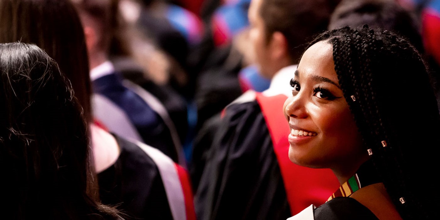 Student looking over her shoulder in the graduation ceremony