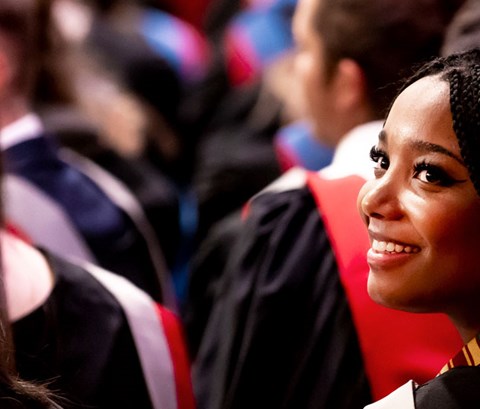 Student looking over her shoulder in the graduation ceremony