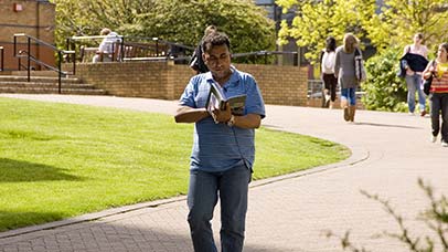 student reading on campus