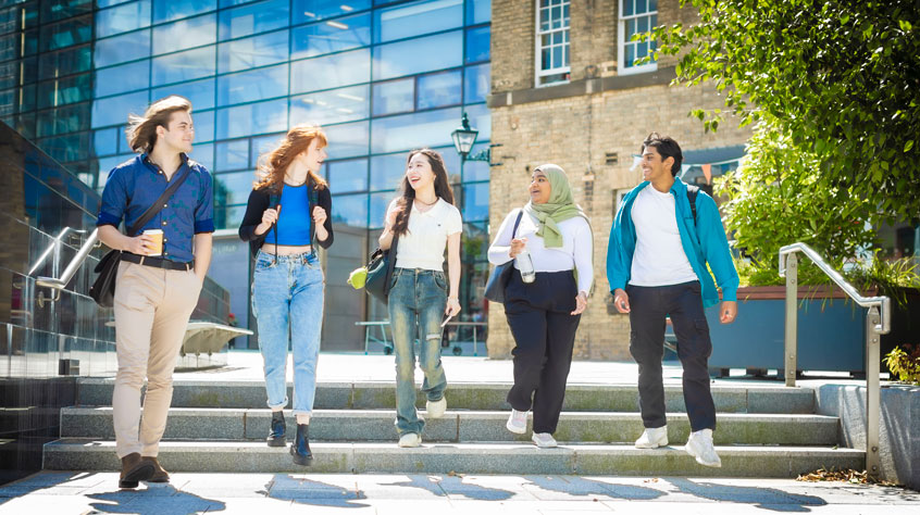 Students walking outside the David Wilson Library on Leicester campus
