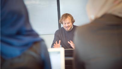 a group of professional learners taking notes in a lecture
