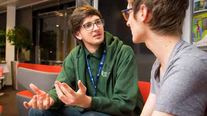 Student and a staff member talking